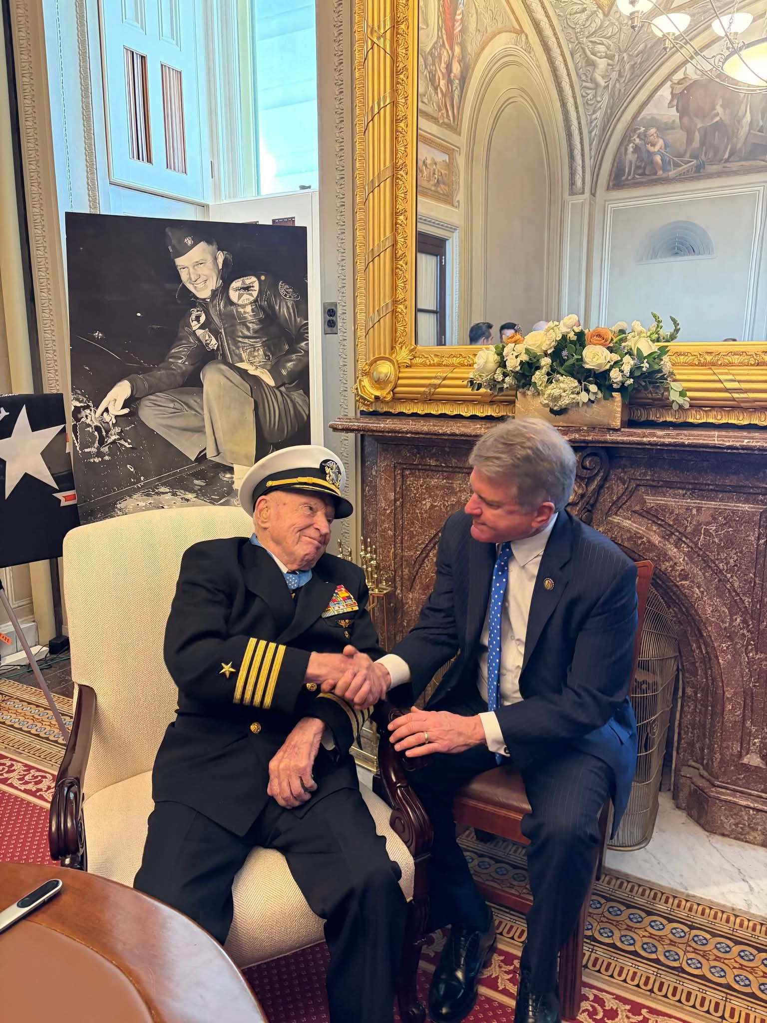Captain Williams at the Capitol with his battle damage photo on display